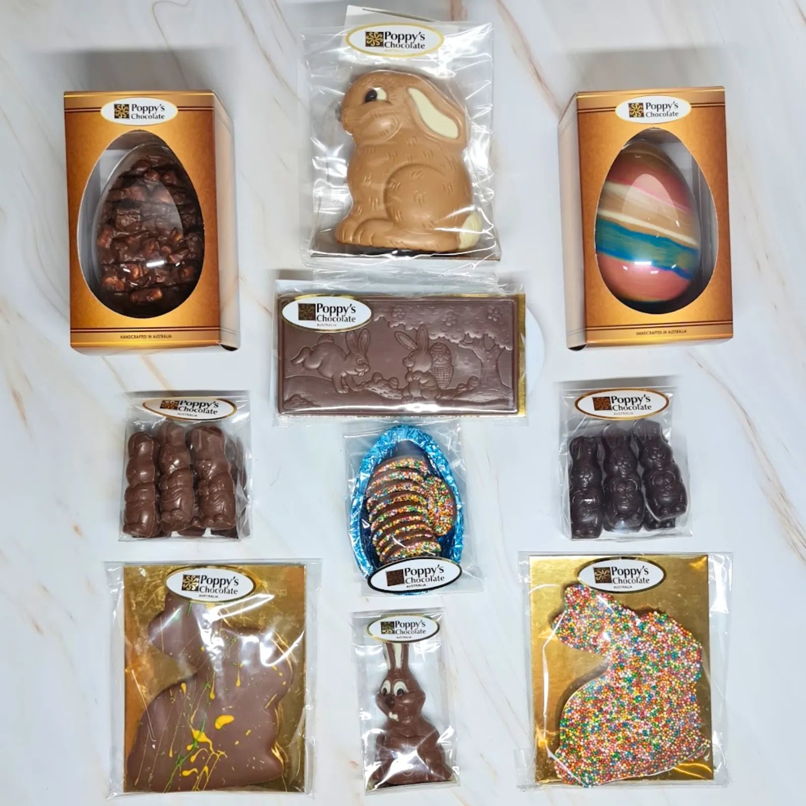 An assortment of Poppys Chocolates in Poppy's Black Hamper Box. The selection includes various Easter Chocolates from Easter Eggs to Easter Bunnies.